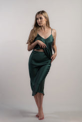 Woman wearing silk closet green skirt and camisole top